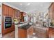 Bright kitchen features tile floors, stainless steel appliances, wooden cabinetry, and natural lighting at 2162 Pine Mountain Nw Rd, Kennesaw, GA 30152