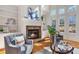 Inviting living room features a cozy fireplace, built-in shelving, and large windows with natural light at 2162 Pine Mountain Nw Rd, Kennesaw, GA 30152