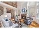 Sunlit living room with fireplace, built-in bookshelves, hardwood flooring, and a staircase to the second floor at 2162 Pine Mountain Nw Rd, Kennesaw, GA 30152