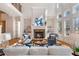 Bright living room featuring a stone fireplace, large windows, hardwood floors, and built-in bookshelves at 2162 Pine Mountain Nw Rd, Kennesaw, GA 30152