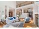 Bright living room boasts hardwood floors, fireplace, and elegant staircase to the second floor at 2162 Pine Mountain Nw Rd, Kennesaw, GA 30152
