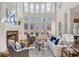 Inviting living room with stone fireplace, built-in bookshelves, tall windows, and hardwood flooring at 2162 Pine Mountain Nw Rd, Kennesaw, GA 30152