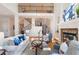 Well-lit living room with stone fireplace, built-in bookshelves, hardwood flooring, and second-story landing at 2162 Pine Mountain Nw Rd, Kennesaw, GA 30152