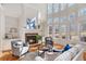 Sunlit living room with fireplace, built-in bookshelves, tall windows, and hardwood floors at 2162 Pine Mountain Nw Rd, Kennesaw, GA 30152