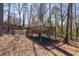 Wooden playhouse with a deck and stairs in a wooded backyard at 2162 Pine Mountain Nw Rd, Kennesaw, GA 30152