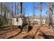 Playhouse in the backyard with stairs, a deck, and the house in the background at 2162 Pine Mountain Nw Rd, Kennesaw, GA 30152