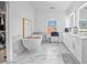 Bright bathroom with standalone tub and vanity with marble surround at 2850 Stonehall Se Ct, Smyrna, GA 30080