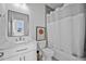 Stylish bathroom featuring a vanity, toilet, bathtub, and a shower with a white shower curtain at 2850 Stonehall Se Ct, Smyrna, GA 30080