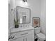 Stylish powder room featuring a marble vanity top and modern fixtures at 2850 Stonehall Se Ct, Smyrna, GA 30080