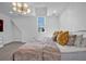 Bright bedroom with white walls, gold light fixture, and cozy, inviting decorative pillows at 2850 Stonehall Se Ct, Smyrna, GA 30080