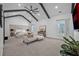 Spacious bedroom with large bed, seating area, and a vaulted ceiling with dark wood beams at 2850 Stonehall Se Ct, Smyrna, GA 30080