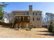 Two-story home backyard featuring a spacious lawn, wooden deck, and a fenced-in yard at 4012 Grand Park Ne Dr, Suwanee, GA 30024