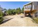 An expansive backyard featuring a wooden deck, a large lawn, and a line of mature trees at 4012 Grand Park Ne Dr, Suwanee, GA 30024