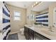 Bathroom featuring a double vanity, large mirror, and blue-and-white striped shower curtain at 4012 Grand Park Ne Dr, Suwanee, GA 30024