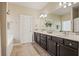 Bathroom featuring a dual sink vanity, soaking tub, tile floors, and a private toilet at 4012 Grand Park Ne Dr, Suwanee, GA 30024