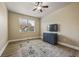 Cozy bedroom with hardwood floors, ceiling fan, and dresser with mounted television at 4012 Grand Park Ne Dr, Suwanee, GA 30024