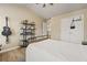 A cozy bedroom with high ceilings, showcasing hardwood floors, modern shelving, and natural light at 4012 Grand Park Ne Dr, Suwanee, GA 30024