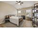 Bright bedroom featuring a vaulted ceiling with ceiling fan and hardwood floors with a stylish metal frame bed at 4012 Grand Park Ne Dr, Suwanee, GA 30024
