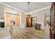 Dining area showcasing wood floors, a chandelier, and a view of the barn door at 4012 Grand Park Ne Dr, Suwanee, GA 30024