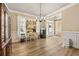 Dining area with wood floors, vintage desk, natural light, and barn door, blending style and function at 4012 Grand Park Ne Dr, Suwanee, GA 30024