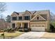 Attractive two-story home with an attached two-car garage and a well-maintained lawn at 4012 Grand Park Ne Dr, Suwanee, GA 30024