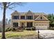 Charming two-story home featuring a manicured front yard and a two-car garage at 4012 Grand Park Ne Dr, Suwanee, GA 30024