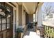 Covered porch features stone accents, seating and decorative floral wreath at 4012 Grand Park Ne Dr, Suwanee, GA 30024