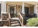 Inviting front porch with stone accents, leading to the home's entrance at 4012 Grand Park Ne Dr, Suwanee, GA 30024