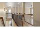 Upstairs hallway features wood floors, wood and iron railing, and lighting at 4012 Grand Park Ne Dr, Suwanee, GA 30024
