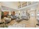 Open living space featuring wood floors, high ceilings, and view to kitchen and staircase at 4012 Grand Park Ne Dr, Suwanee, GA 30024