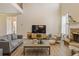 Comfortable living room featuring a stone fireplace, wood floors, and natural light at 4012 Grand Park Ne Dr, Suwanee, GA 30024