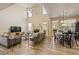 Bright, open living space featuring a stone fireplace, high ceilings, and seamless flow to the dining area at 4012 Grand Park Ne Dr, Suwanee, GA 30024