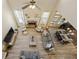 Open-concept living room featuring hardwood floors, a fireplace, large windows and dining area at 4012 Grand Park Ne Dr, Suwanee, GA 30024