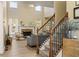 Open-concept living room with a fireplace, natural light, and staircase access at 4012 Grand Park Ne Dr, Suwanee, GA 30024