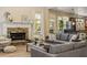 Cozy living room features a stone fireplace and comfortable gray sectional sofa at 4012 Grand Park Ne Dr, Suwanee, GA 30024