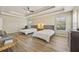 Main bedroom with hardwood floors, tray ceiling, natural light, and two beds at 4012 Grand Park Ne Dr, Suwanee, GA 30024