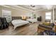 Spacious main bedroom featuring two beds, natural light, a ceiling fan, and hardwood floors at 4012 Grand Park Ne Dr, Suwanee, GA 30024