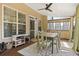 Inviting covered patio features a dining set, ceiling fan, and an exterior door to the house at 4012 Grand Park Ne Dr, Suwanee, GA 30024