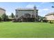Spacious backyard with a well-maintained lawn and a two-story home featuring a wooden deck at 4249 Caveat Ct, Fairburn, GA 30213
