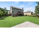Expansive backyard with lush green lawn and a charming two-story house at 4249 Caveat Ct, Fairburn, GA 30213