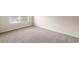 Bright room with neutral walls and neutral carpet at 4249 Caveat Ct, Fairburn, GA 30213