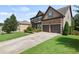 Attractive home with a two-car garage, landscaped front yard, and large driveway at 4249 Caveat Ct, Fairburn, GA 30213