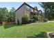 Exterior view of home with well-maintained lawn, landscaping, and two-car garage at 4249 Caveat Ct, Fairburn, GA 30213