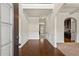 Inviting foyer with hardwood floors, white wainscoting, and an open floor plan at 4249 Caveat Ct, Fairburn, GA 30213