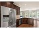 Spacious kitchen with stainless steel fridge, granite counters, and an adjacent breakfast area at 4249 Caveat Ct, Fairburn, GA 30213