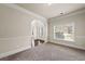 Well-lit living room with plush carpeting and an open entryway at 4249 Caveat Ct, Fairburn, GA 30213