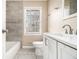Modern bathroom with a white vanity, grey tiled wall, and updated fixtures at 5257 Orly Ter, Atlanta, GA 30349