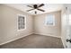 Comfortable bedroom featuring neutral carpeting, ceiling fan and a large window at 5257 Orly Ter, Atlanta, GA 30349