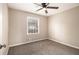 Neutral bedroom features plush carpet, a ceiling fan, and a window with natural light at 5257 Orly Ter, Atlanta, GA 30349