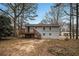 Back exterior view of the home with deck, stairs and mature trees at 5257 Orly Ter, Atlanta, GA 30349